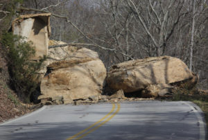 Several large boulders block the W Road after a rockslide.